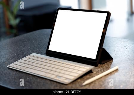 Blank screen laptop computer modern man use room laptop with blank white desktop screen with coffee cup on wooden table in cafe Stock Photo