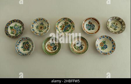 Salaj, Transylvania, Romania- May 11, 2018: hand-painted plates decorating the walls of a house, traditional Romanian handmade ceramics Stock Photo
