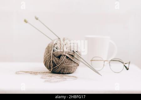 Threads for knitting, from natural environmentally friendly wool, close-up on a light background. Hobby home needlework Stock Photo