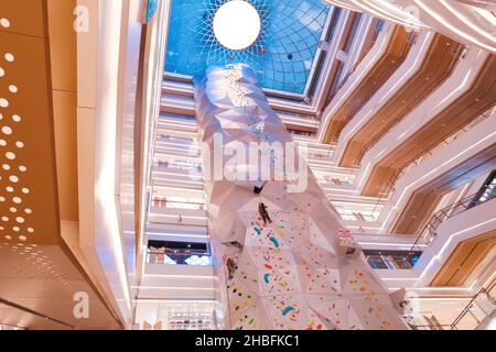 SHANGHAI, CHINA - DECEMBER 19, 2021 - Winter fitness enthusiasts experience the world's tallest indoor rock climbing wall at the New World Mall, a com Stock Photo