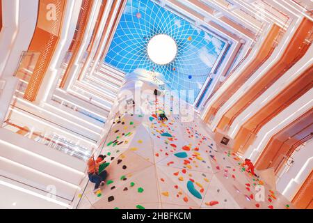 SHANGHAI, CHINA - DECEMBER 19, 2021 - Winter fitness enthusiasts experience the world's tallest indoor rock climbing wall at the New World Mall, a com Stock Photo