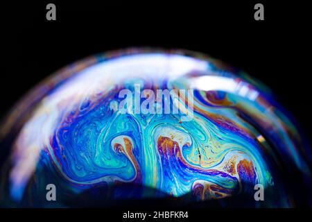Abstract pattern, multicolored chaotic texture inside of the soap bubble, closeup Stock Photo