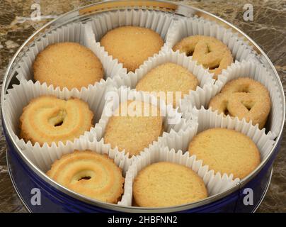 Butter shortbread cookies in paper cups in round cookie tin Stock Photo