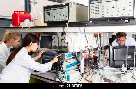 Students performing experiments in laboratory Stock Photo