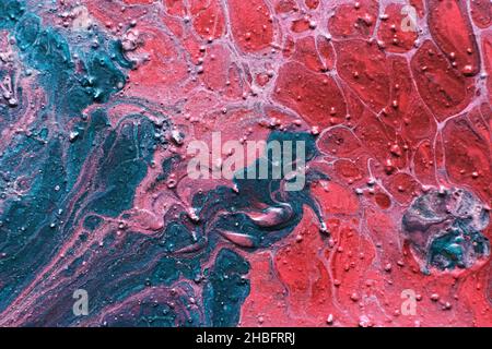 Fluid Art. Embossed strokes, craters and drips of red and green paint. Marble effect background or texture Stock Photo