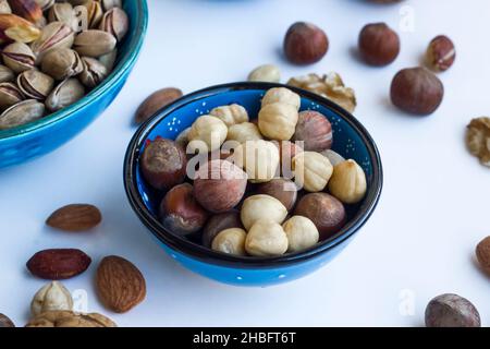 New crop hazelnuts in ceramic bowl with nut crusher on the wooden
