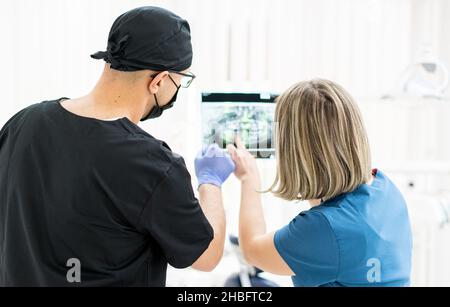 Two doctors checking x-ray image in hospital, quality photo  Stock Photo
