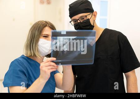 Two doctors checking x-ray image in hospital, quality photo  Stock Photo