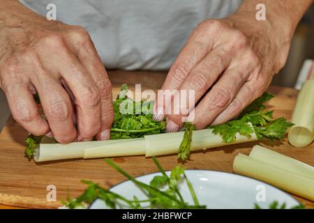Chef prepares bouquet of herbs and herbs in the kitchen for dressing the dish Stock Photo