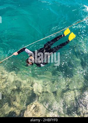 Hurghada, Egypt - May 28, 2021: Man snokeling in Makadi Bay, which one of Egypt beautiful Red Sea Riviera. Stock Photo