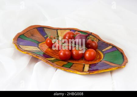 vegetables on a clay plate - white background Stock Photo
