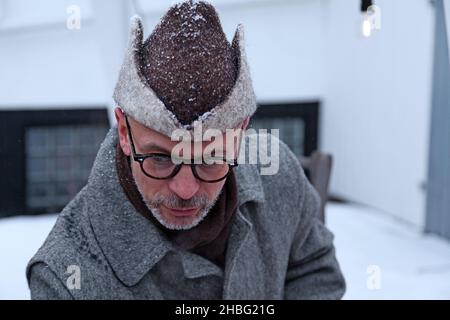 Umea, Norrland Sweden - December 11, 2021: man with funny winter hat at Christmas market Stock Photo