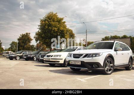 Chernihiv, Ukraine - July 24, 2021: Saab cars stand in a row in a parking lot. Different models of the car Saab. Saab 9-5X, 9-3 and Saab 9-5 against t Stock Photo