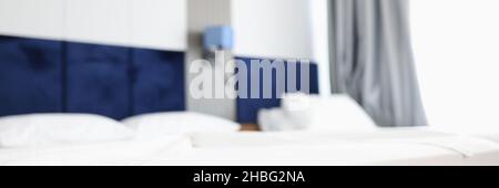 Modern hotel bedroom with two beds blurred background Stock Photo