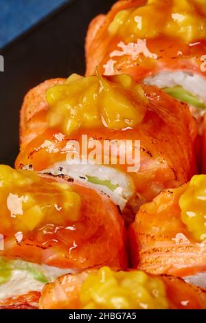 Macro shot of uramaki rolls with seared salmon and caramelized mango Stock Photo