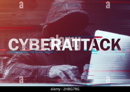 Cyberattack concept, hooded computer hacker working on laptop, glitch effect added in post, selective focus Stock Photo