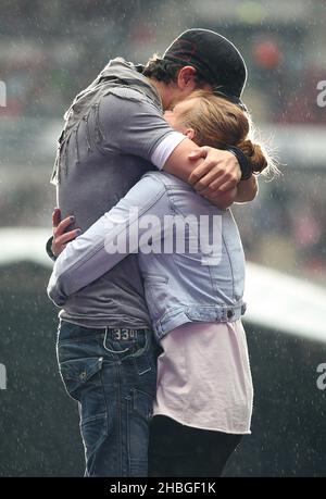 Enrique Iglesias with fan Sophie Elphick on stage during Capital FM's Summertime Ball at Wembley Stadium, London. Stock Photo