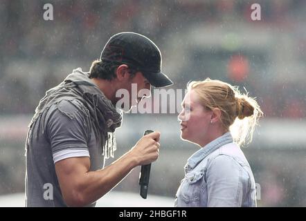 Enrique Iglesias with fan Sophie Elphick on stage during Capital FM's Summertime Ball at Wembley Stadium, London. Stock Photo