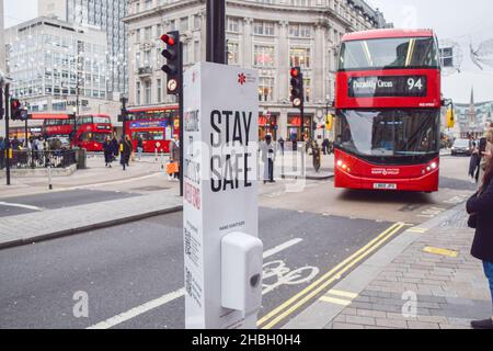 London, UK 17th December 2021. 'Stay Safe' signs with hand sanitisers have been installed in Oxford Street and Regent Street as the Omicron variant of COVID-19 spreads in the UK. Stock Photo