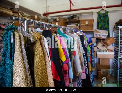 The interior and items of a vintage thrift clothing store with ...