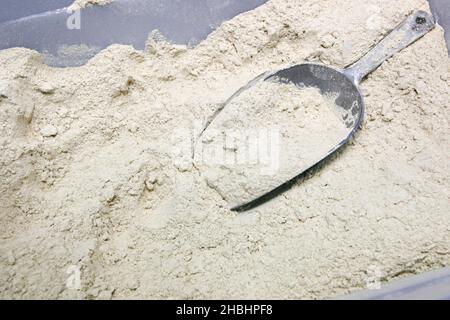 Baking Concept - close up of wheat flour with scoop Stock Photo