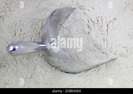 Baking Concept - close up of wheat flour with scoop Stock Photo