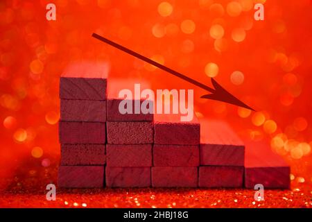 Podium for product presentation. Minimalistic staircase made of wooden cubes with a down arrow. A scene with geometric shapes. On a shiny red background. High quality photo Stock Photo