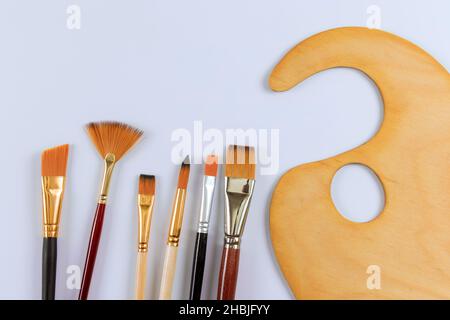 Drawing tools with paint artist brushes and palette for paint on white isolated Stock Photo