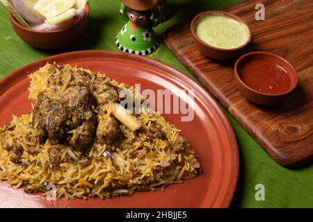 Shot of the spicy hot mutton biryani served in a brown plate Stock Photo