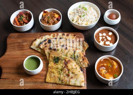 Shot of the roti sliced and types of side dishes kept on the table for taste........... Stock Photo