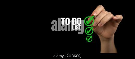 To do list with checklist boxes. Hand marking with pen on a black background, banner Stock Photo