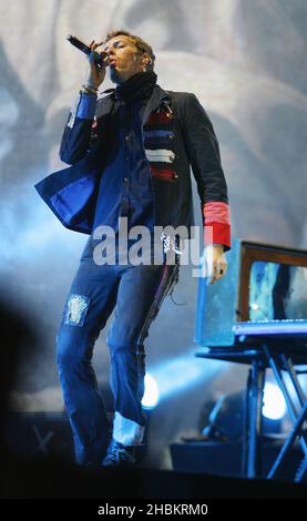 Chris Martin of Coldplay performs on stage at Wembley Stadium, North London. Stock Photo