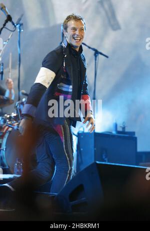 Chris Martin of Coldplay performs on stage at Wembley Stadium, North London. Stock Photo