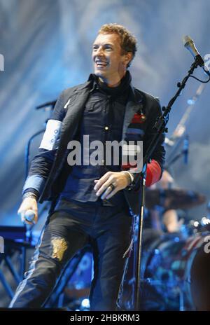 Chris Martin of Coldplay performs on stage at Wembley Stadium, North London. Stock Photo