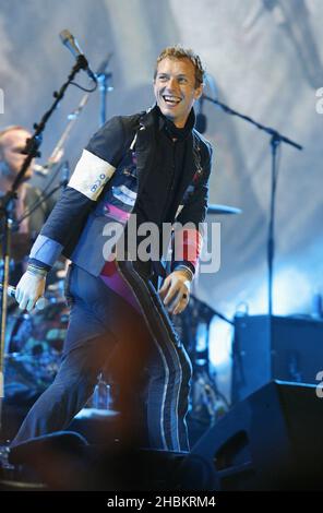 Chris Martin of Coldplay performs on stage at Wembley Stadium, North London. Stock Photo