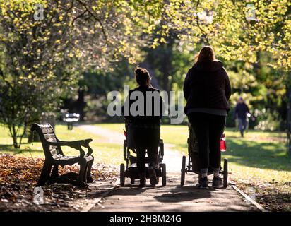 Two young mothers in Collett Park in Shepton Mallet, Somerset, UK Stock Photo