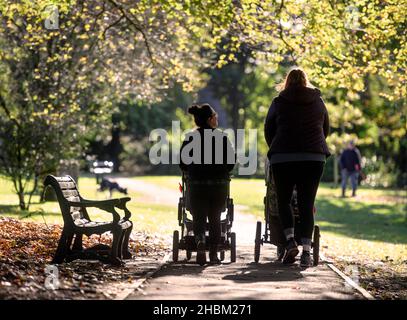 Two young mothers in Collett Park in Shepton Mallet, Somerset, UK Stock Photo