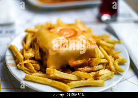 Delicious traditional francesinha served with french fries, Porto, Portugal Stock Photo