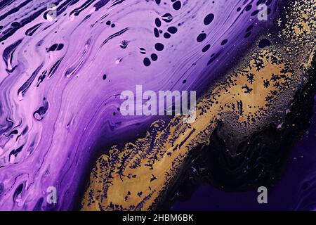 Metallic gold abstraction on purple waves. Fluid Art. Marble effect background or texture Stock Photo