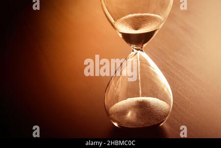 Time past concept with hourglass. Sand running through the bulbs. Stock Photo