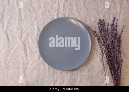 Grey blue colored circle shaped ceramic plate on isolated background, food mockup Stock Photo