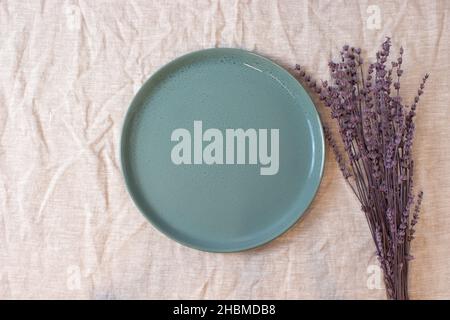 Green colored circle shaped ceramic plate on isolated background, food mockup Stock Photo