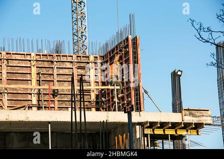 Construction of a high-rise building. Workers prepare formwork for pouring concrete. Stock Photo