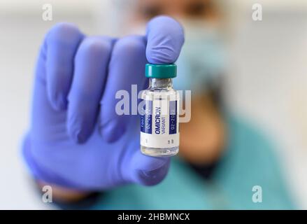 Selective focus, focus on foreground ph of doctor holding covid vaccine vial with booster dose Stock Photo