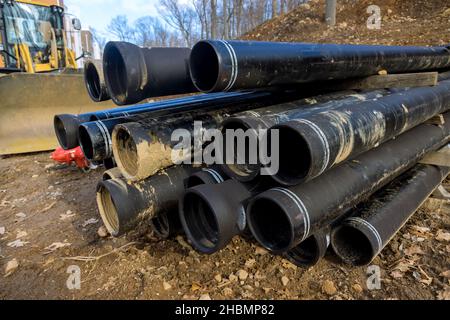 Polyethylene pipes for a water supply system for laying urban communications of home on plastic main black pipes Stock Photo