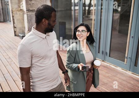 Waist up portrait of two business people walking in city, copy space Stock Photo