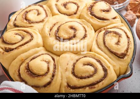 Cinnamon rolls or cinnabon homemade recipe raw dough preparation sweet traditional dessert buns pastry food baked homemade swirl Danish mini snack. Fo Stock Photo