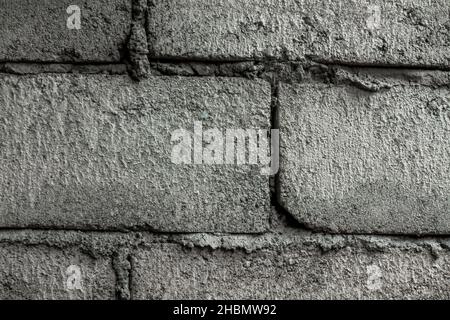The brick walls that are not plastered are gray, have a rough surface, used for the background Stock Photo