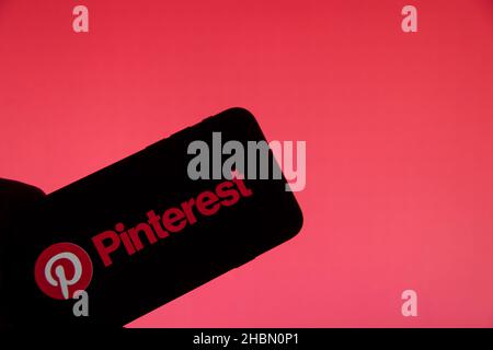 Rheinbach, Germany  20 December 2021,  The brand logo of the online pin board 'Pinterest' on the display of a smartphone (focus on the brand logo) Stock Photo