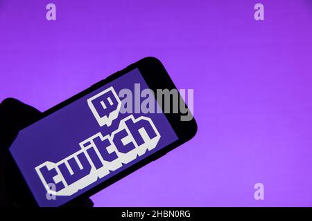Rheinbach, Germany  20 December 2021,  The brand logo of the live streaming service 'Twitch' on the display of a smartphone (focus on the brand logo) Stock Photo